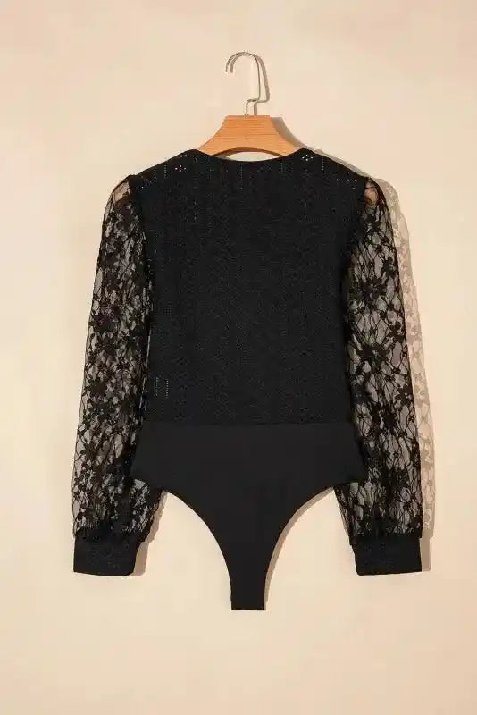 Back view of Lace Sleeve Bodysuit on hanger with floral lace sleeves and textured fabric, ideal for elegant occasions.