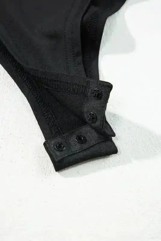 Open snap closure of Lace Sleeve Bodysuit showing button fastenings for ease and comfort in wear.