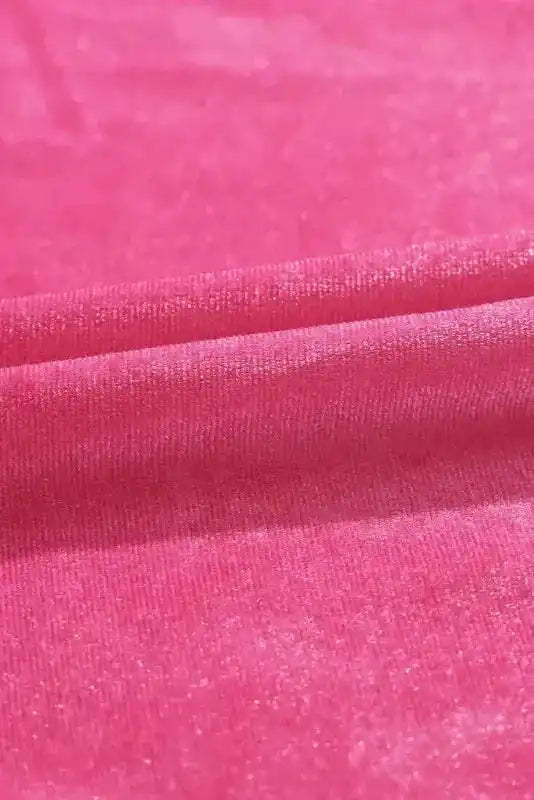 Detail of soft pink velvet fabric used in the Frilled Neck Smocked Bodice Velvet Dress, showcasing its luxurious sheen and texture.