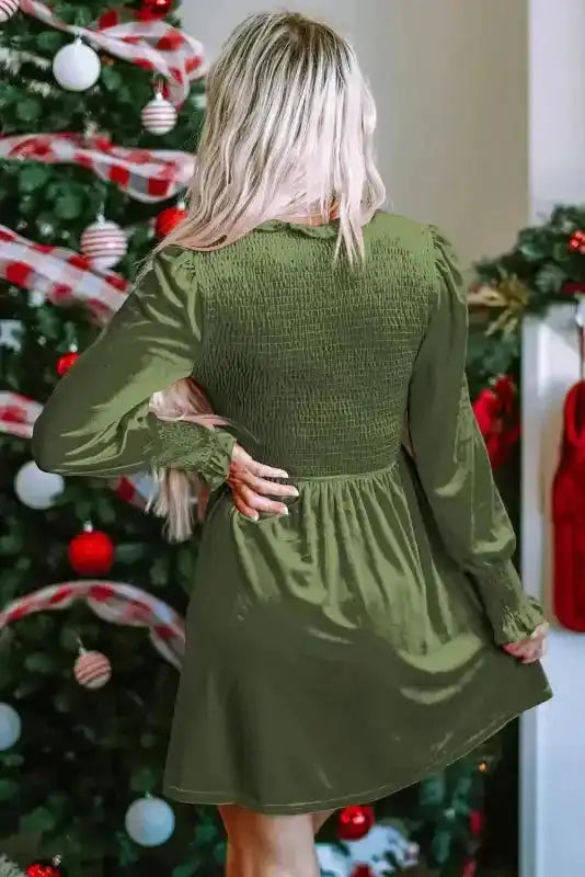 Back view of green Frilled Neck Smocked Bodice Velvet Dress showing smocked detailing and flared skirt, ideal for daily or evening wear.