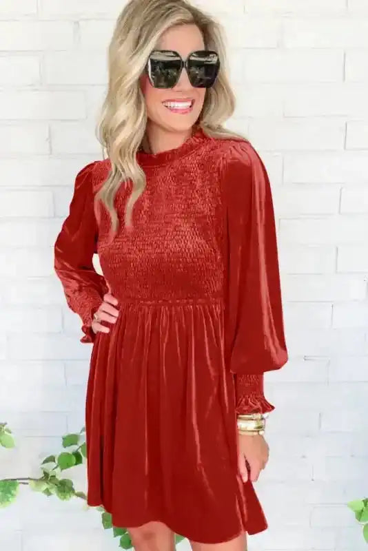 Elegant red smocked velvet dress with long sleeves and feminine silhouette, styled for a Southern Belle look.