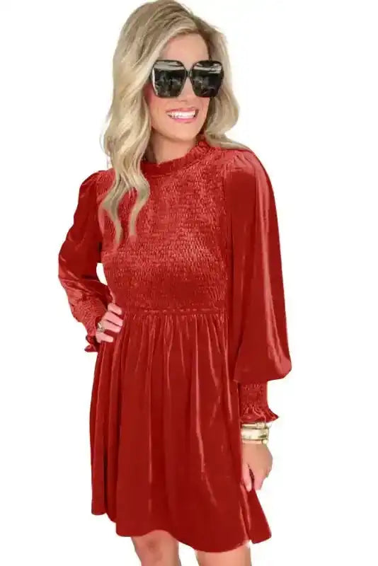 Red Frilled Neck Smocked Bodice Velvet Dress on white background, highlighting its luxurious velvet fabric and flattering fit.