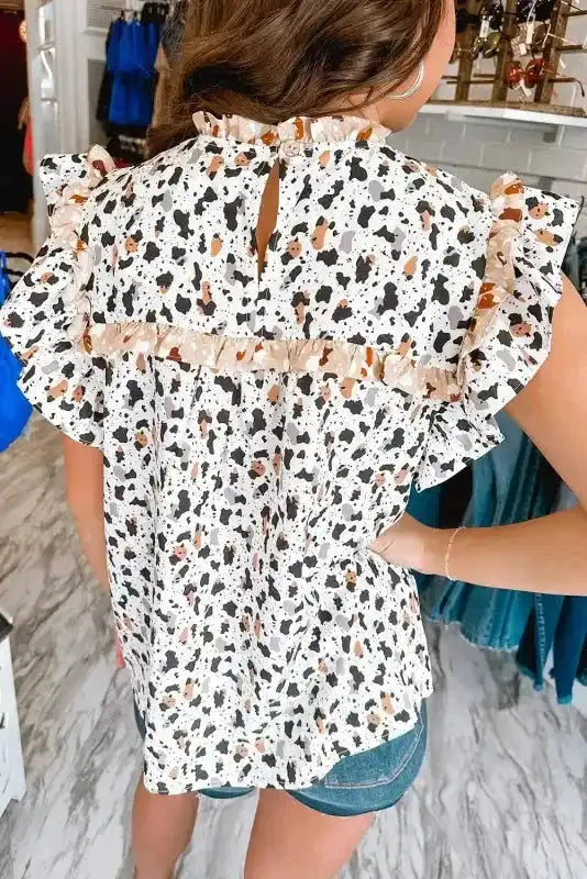 Side view of Leopard Ruffle Trim Stand Neck Blouse showing flutter sleeve drape and tiered hem — Fashionfitz