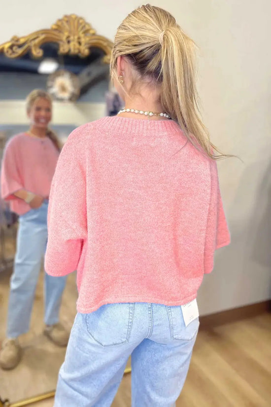 Back view of pastel peach fuzzy knit cardigan with relaxed boxy silhouette and short sleeves, ideal for layering.