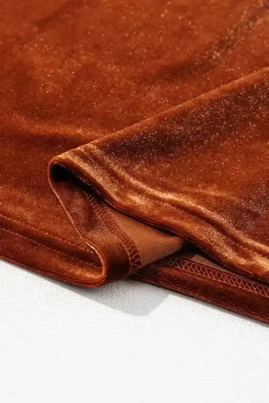 Detailed view of the hem on the Gold Flame Beaded Velvet Top, showcasing quality stitching and soft velvet lining.