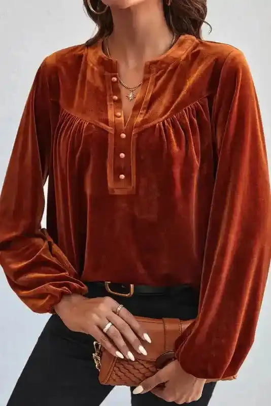 Elegant Gold Flame Beaded Velvet Top paired with a brown clutch, highlighting its beaded neckline and soft velvet fabric.