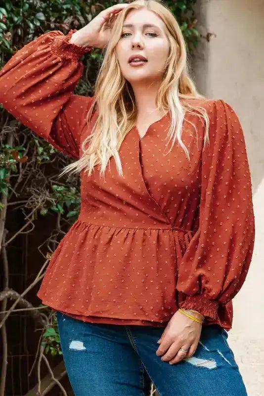 Gold Flame Swiss Dot Blouse in plus size with long puff sleeves and peplum waist, styled casually with ripped jeans for a chic UK look.