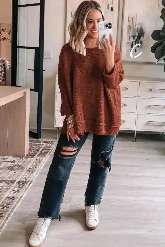 Women's Gold Flame Textured Crew Neck Loose Sweater paired with ripped jeans and sneakers, showcasing a casual winter look.