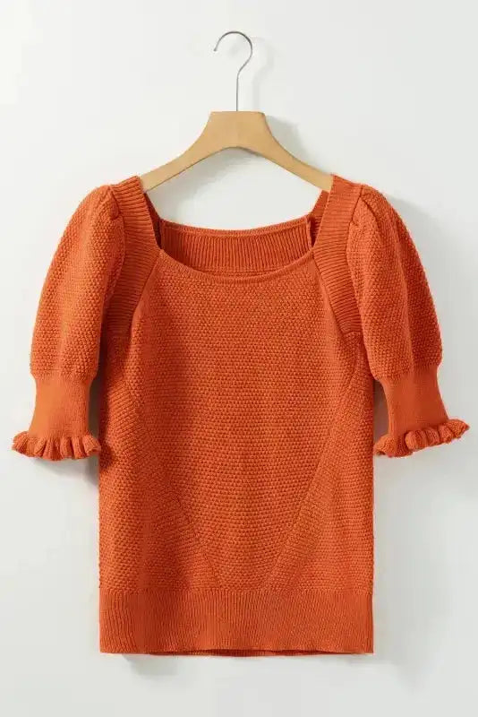 Rust textured knit crop top with square neckline and bubble sleeves displayed on hanger, ideal for summer styling.