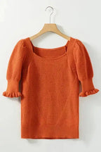 Rust textured knit crop top with square neckline and bubble sleeves displayed on hanger, ideal for summer styling.