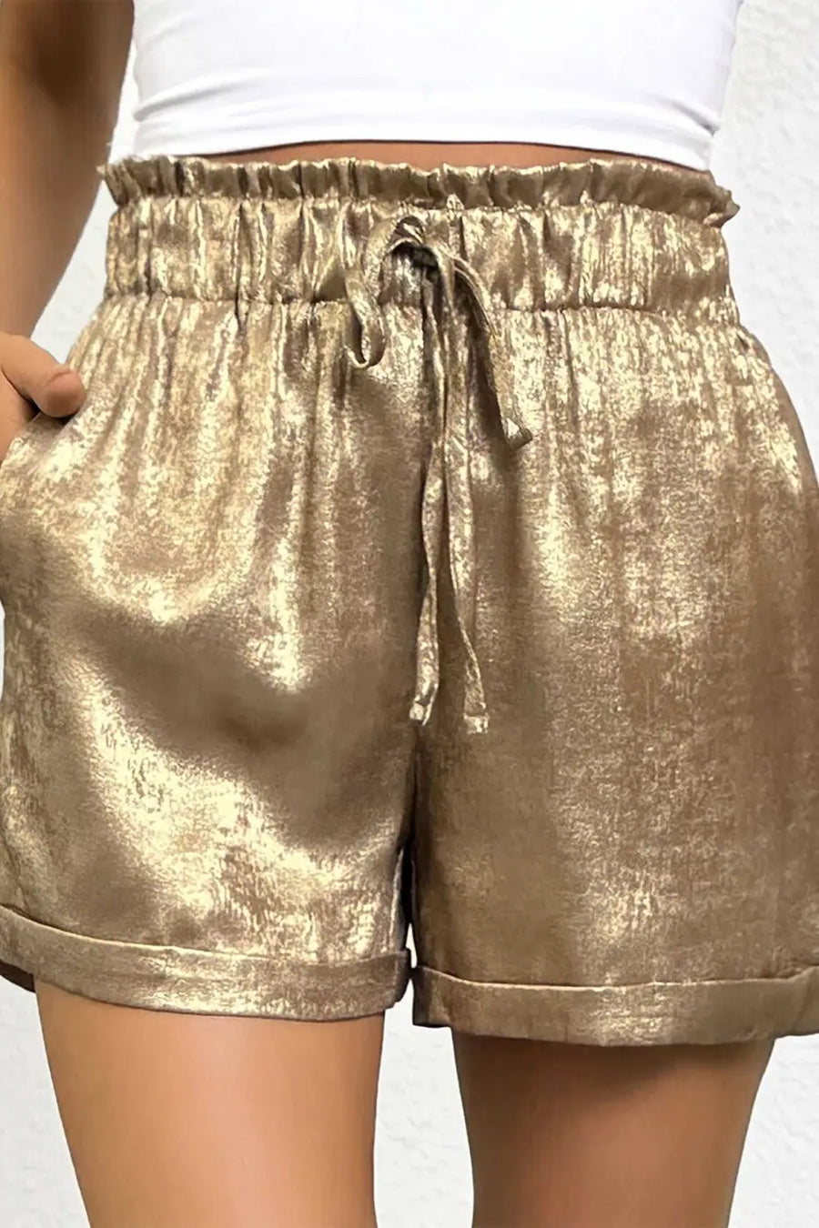 High waist Gold Metallic Shorts Women with drawstring and rolled hem, crafted from metallic fabric for a statement summer style.