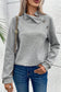 Gray high neck textured sweater with an asymmetrical collar and decorative buttons