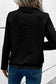 Black high neck textured jacket with geometric pattern paired with blue jeans. Relax relax