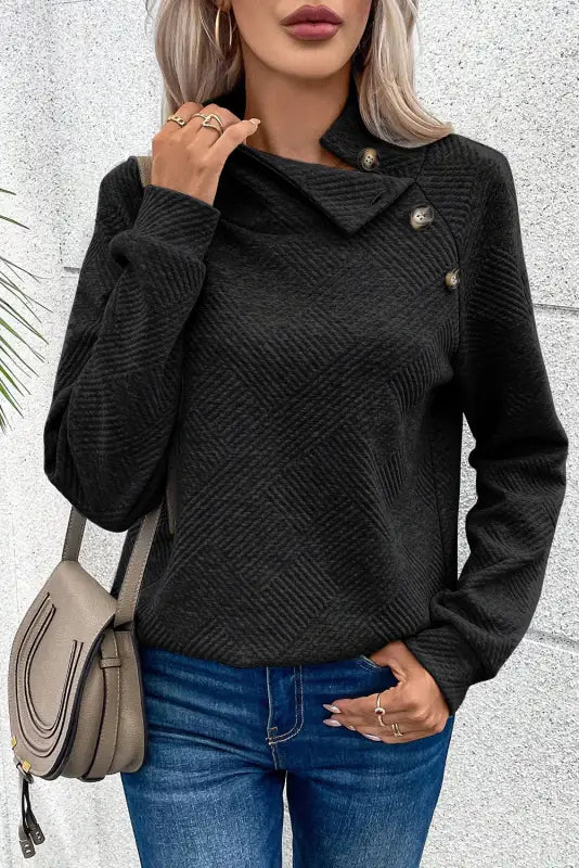 Gray high neck textured sweater with asymmetrical collar and decorative buttons