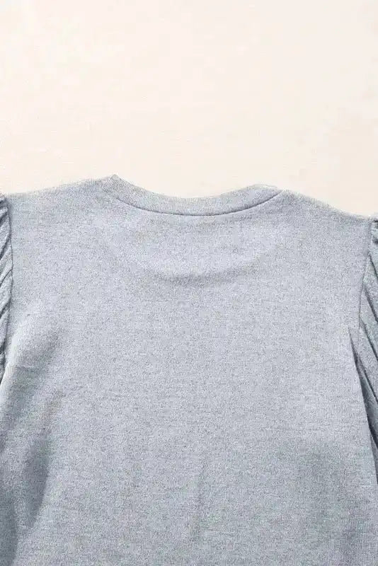 Detailed view of back neckline on Ribbed Bishop Sleeve Top in grey, emphasizing the smooth knit texture.