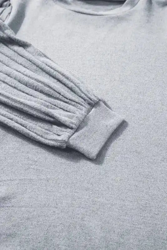 Sleeve and cuff detail of grey Ribbed Bishop Sleeve Top, showing ribbed texture and comfortable fit.