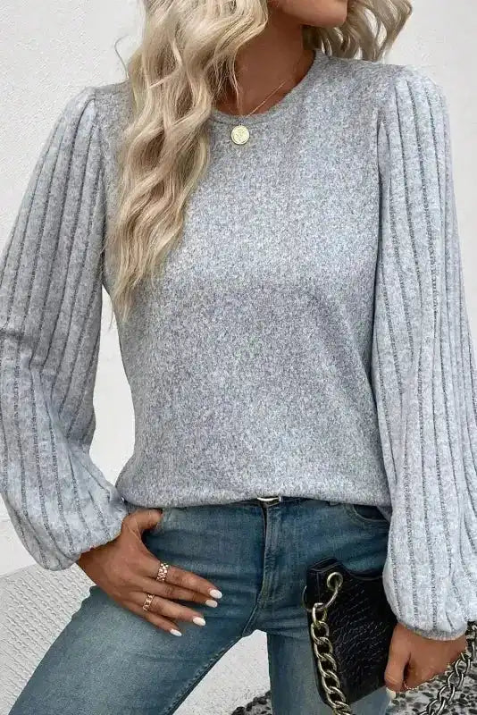 Stylish grey Ribbed Bishop Sleeve Top paired with denim, highlighting the unique ribbed sleeves and flattering silhouette.