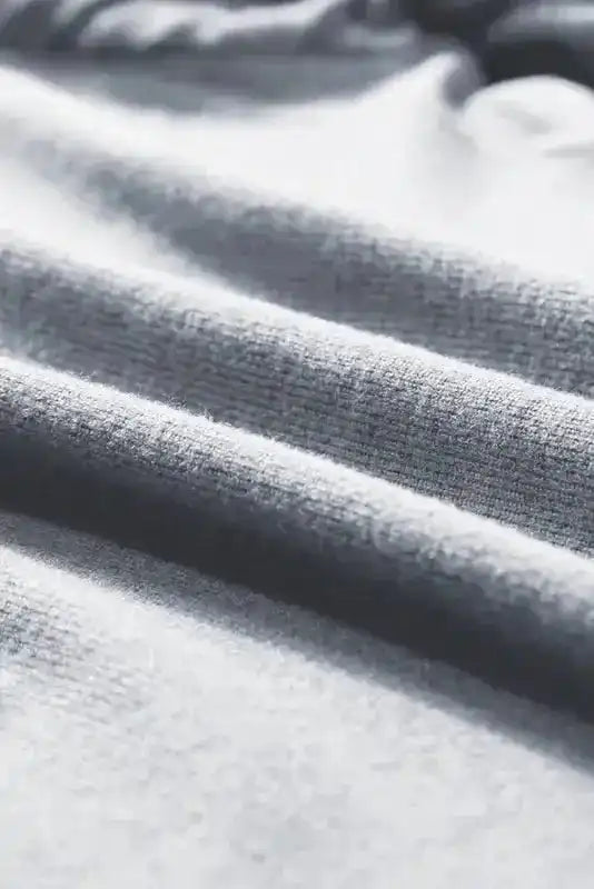 Close-up of textured knit fabric on grey Ribbed Bishop Sleeve Top, ideal for cozy fall fashion.