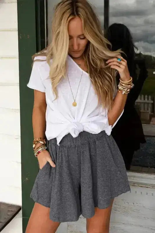 Gray Lambada shorts with elastic waist styled with a white tee and layered bracelets, perfect for daily casual wear.