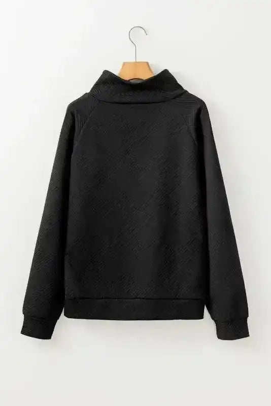 Back flat lay of black textured pullover sweater with ribbed fabric and relaxed fit, ideal for cold weather layering.