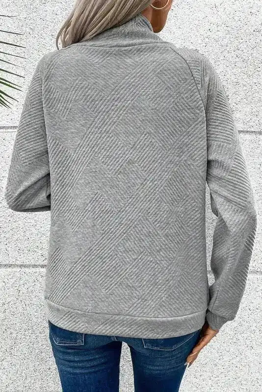 Back view of gray ribbed pullover top with geometric texture and relaxed fit, perfect for daily winter wear.