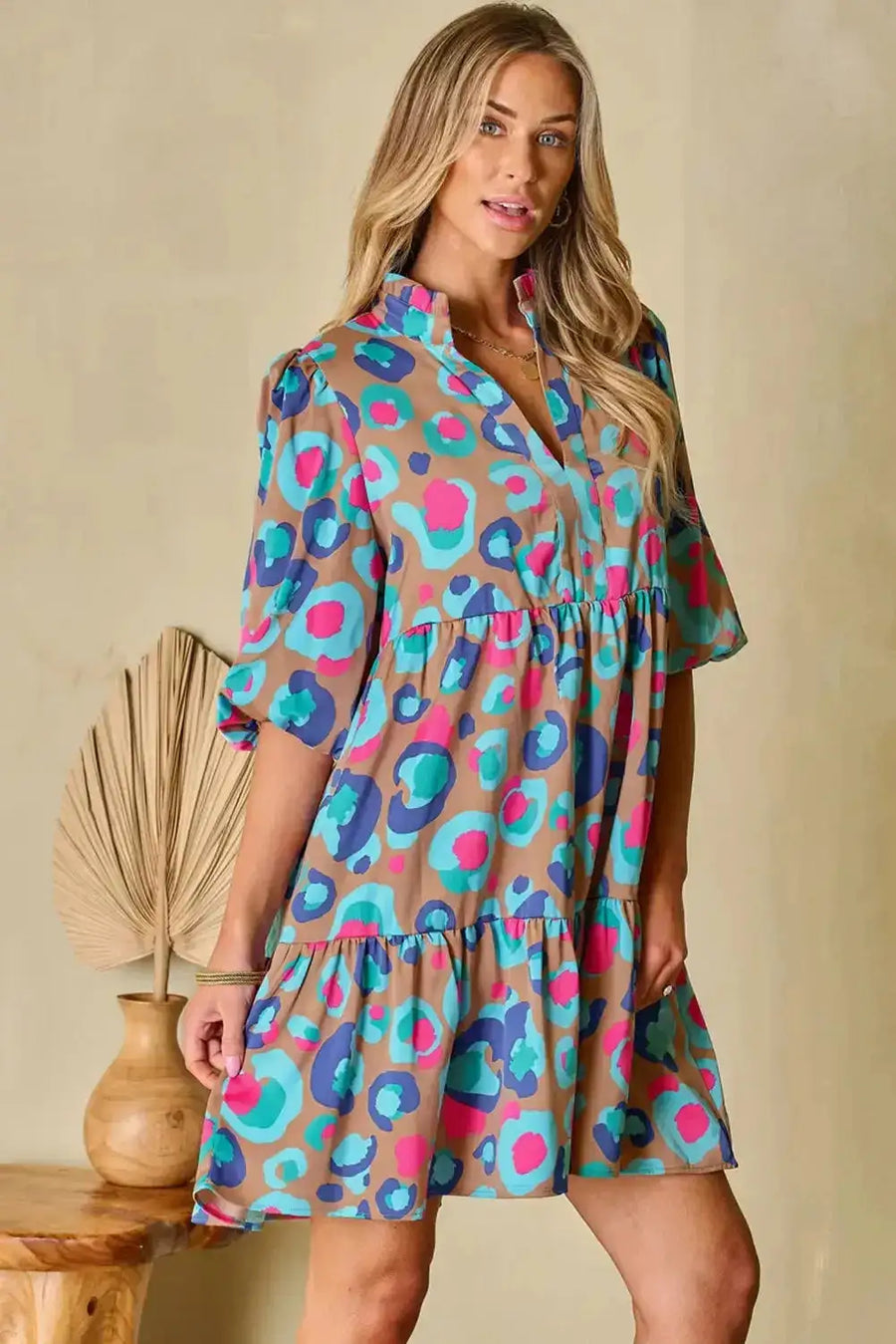 Model posing in multi-colour tiered mini dress with bubble sleeves, perfect for standout style in UK women's casual fashion.