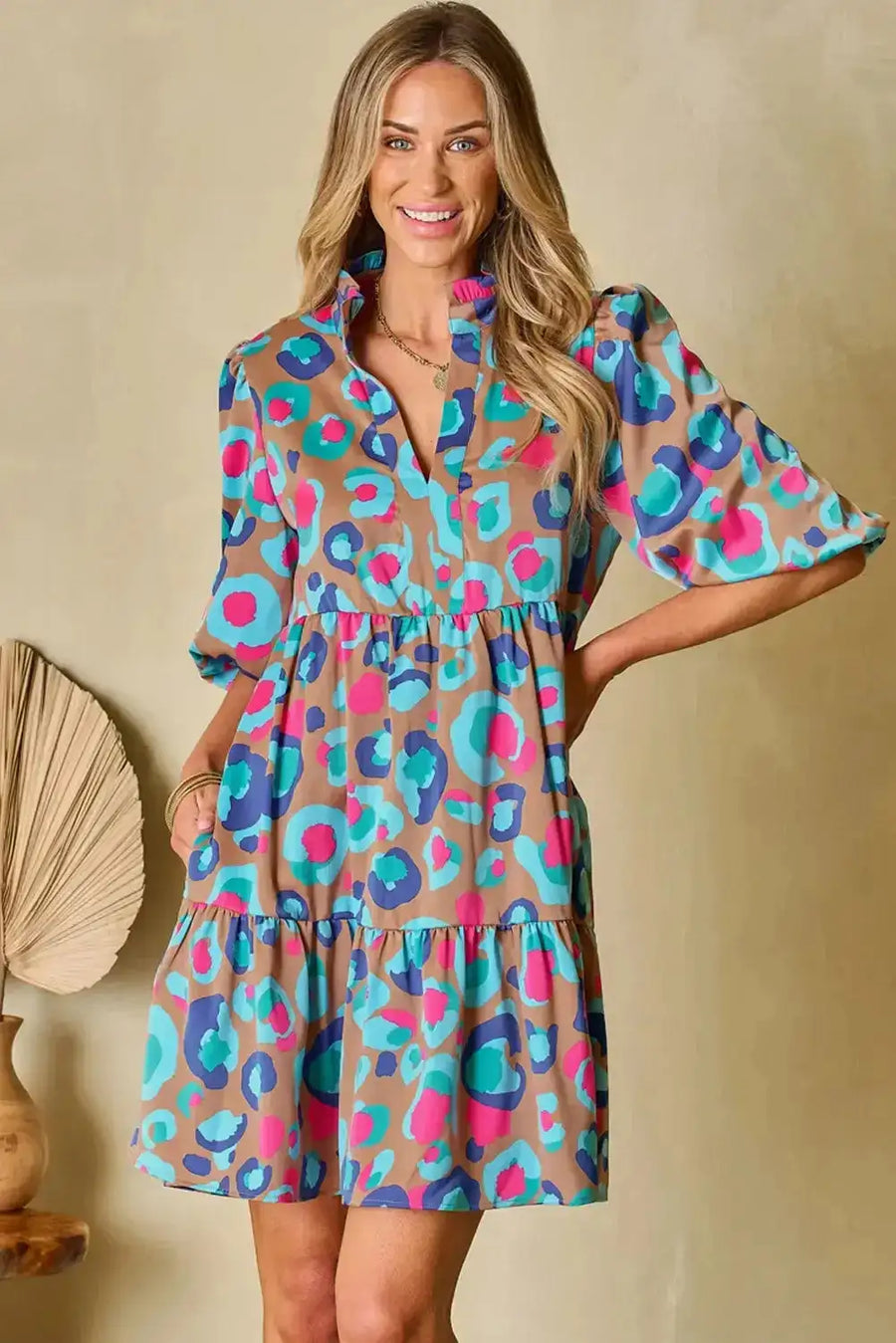 Front view of bubble sleeve mini dress in multi-colour print, designed with a tiered silhouette and v-neck for a trendy UK style.