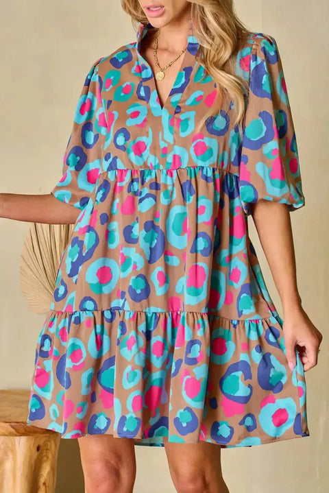 Multi-colour tiered mini dress with bubble sleeves and v-neckline, featuring vibrant abstract print and relaxed fit for stylish comfort.