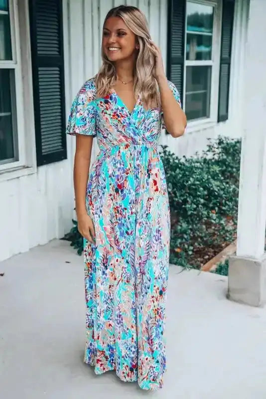 Summer-ready floral wrap maxi dress in green with V-neck and abstract print, designed for comfort and elegance in warm weather.