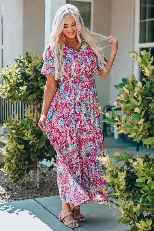 Side view of pink floral maxi dress with v-neck and flutter sleeves, ideal for warm weather and casual events.