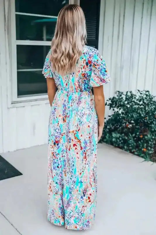 Back view of green floral maxi dress with V-neck and wrap style, showcasing the lightweight fabric and relaxed fit.