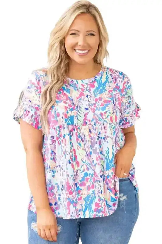 Floral print babydoll top with short sleeves and round neckline in pastel tones, perfect for warm weather styling.