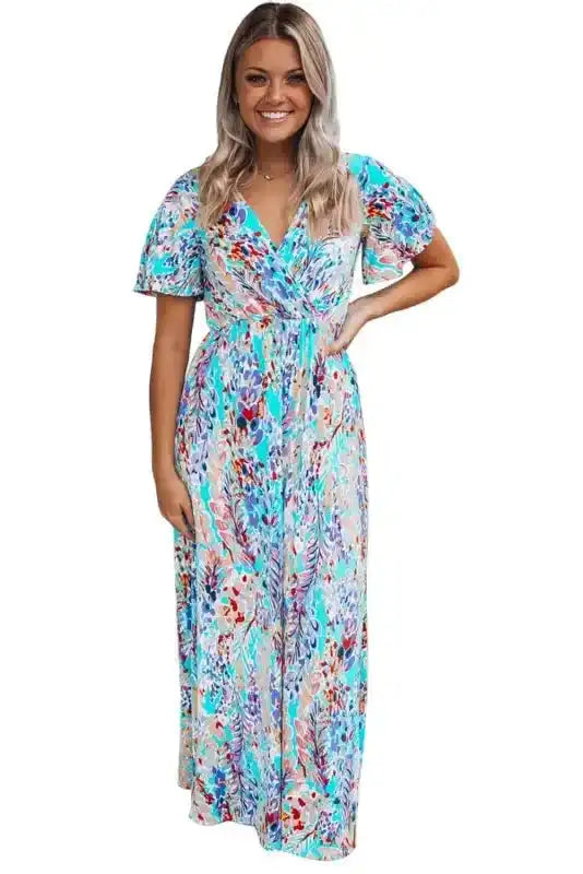 Woman wearing green floral maxi dress with v-neck and wrap top, styled for casual summer outings or vacations.