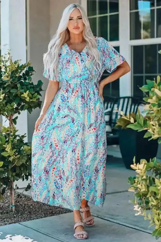 Floral Maxi Dress with V Neck in green, styled with sandals and featuring a relaxed fit and colorful abstract print for summer.