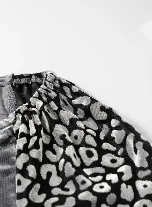 Gathered shoulder seam of leopard print sleeve, showcasing the blouse’s stylish construction and splicing design.