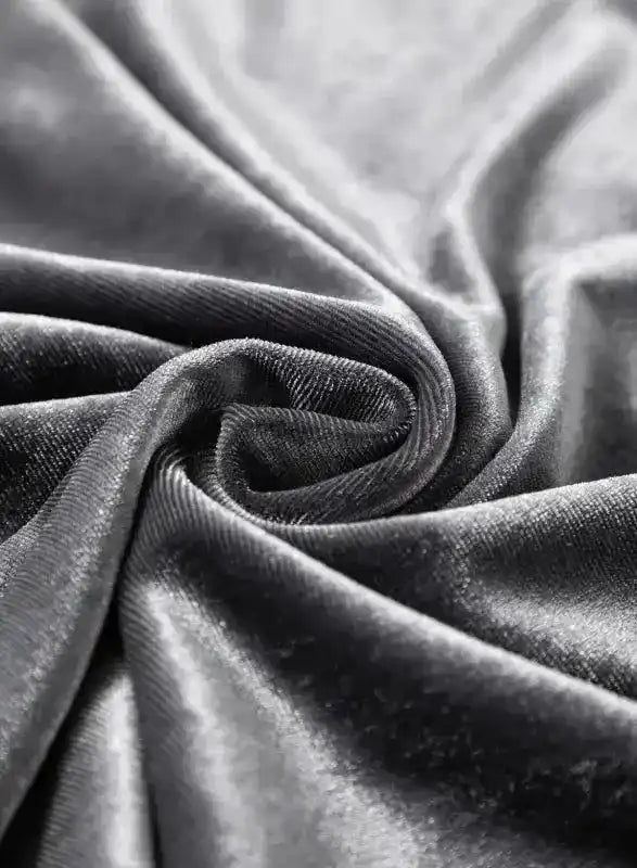 Detailed view of luxurious grey velvet fabric twisted to show its sheen and softness, ideal for elegant blouse designs.