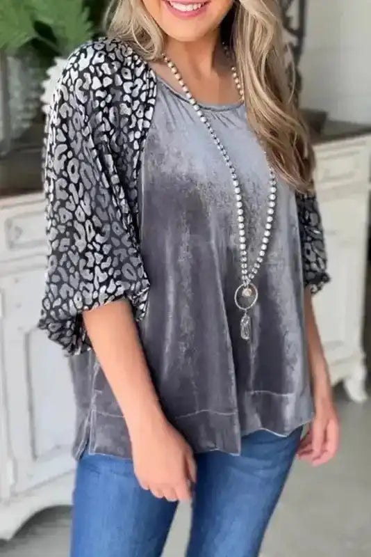 Grey Leopard Velvet Blouse with lantern sleeves, blending soft velvet body and bold leopard print sleeves for a chic fall fashion statement.