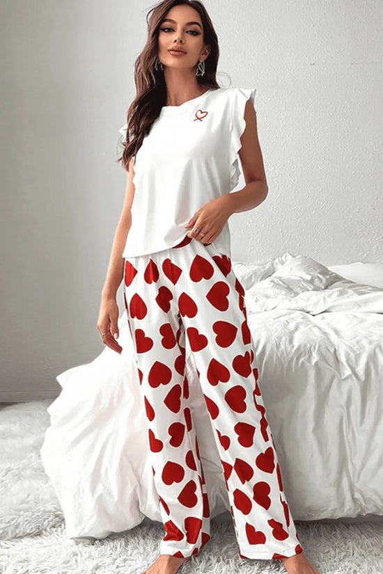 Woman wearing a Heart Print Pants Lounge Set in a bedroom setting.