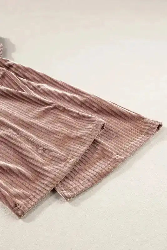 Detail of flared hem on women's corduroy pants, emphasizing wide leg silhouette and soft winter-ready fabric.