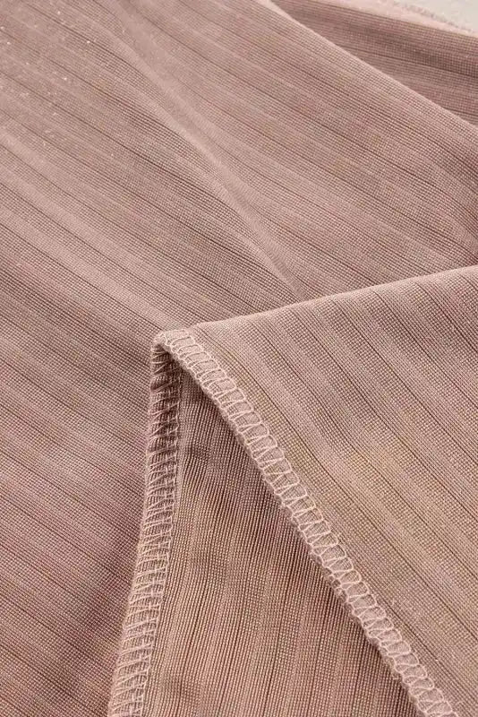 Close-up of inner seam and stitching on women's corduroy flare pants, revealing durable construction and fine ribbed fabric.