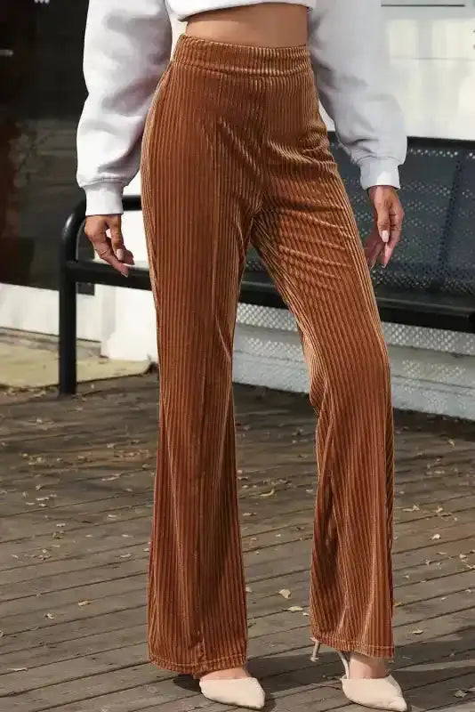 Side angle of women's high waist corduroy pants with flared legs, styled for casual winter outings in a modern look.