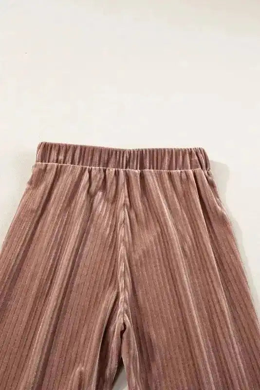 Rear waistband detail of women's high waist flare corduroy pants, highlighting elastic band and ribbed corduroy texture.