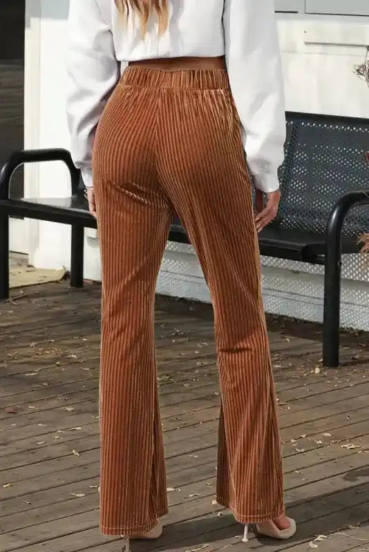 Back outdoor view of chic women's flare corduroy pants, showing flattering fit and soft wide leg silhouette for daily wear.