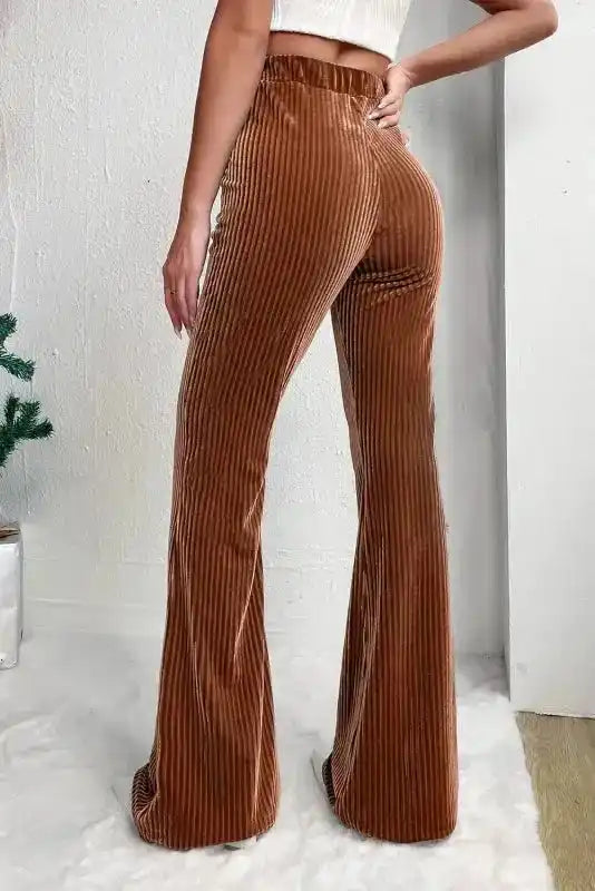 Back view of women's chic flare corduroy pants in brown, highlighting the flattering high waist and flared silhouette.