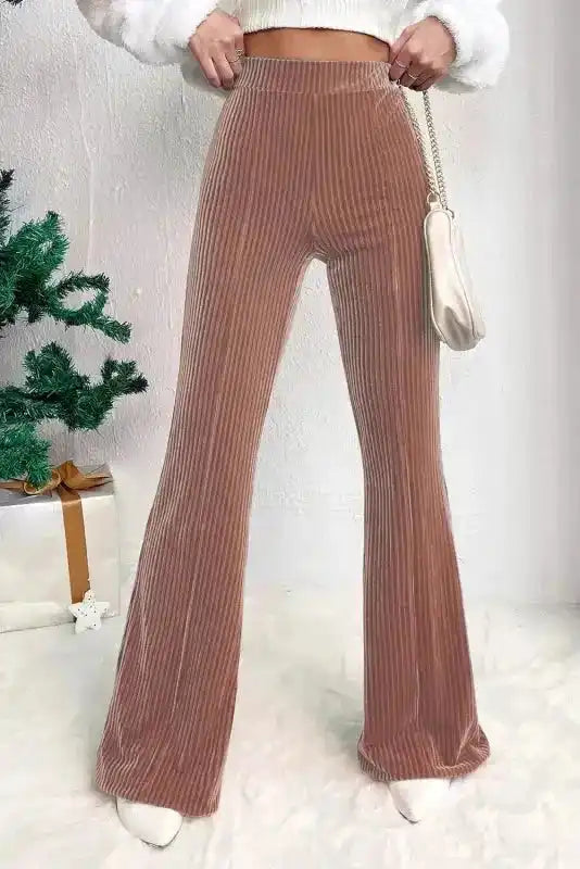 Chic women's flare corduroy pants in high waist design with wide leg silhouette, styled for winter fashion and casual daily wear.
