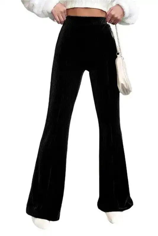 Women's black flare corduroy pants with high waist design, styled for a sleek and comfortable winter wardrobe essential.