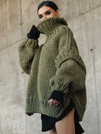 Olive green fluffy chunky knit turtleneck jumper styled with black layers, ideal for cozy autumn and winter fashion.