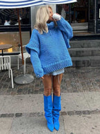 Blue fluffy chunky knit turtleneck jumper styled with denim shorts and blue boots, perfect for bold fall fashion.