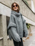 Gray fluffy chunky knit turtleneck jumper with oversized sleeves, styled for a casual and warm winter outfit.
