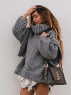 Gray fluffy chunky knit turtleneck jumper styled with a crossbody bag and distressed shorts, great for fall layering.